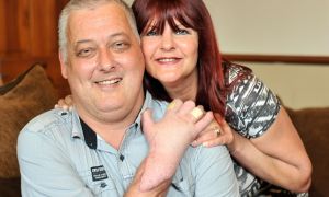 Britain’s first ever hand transplant patient Mark Cahill with his wife Sylvia at home in Halifax Image Credit: Bruce Adams/Rex/Shutterstock