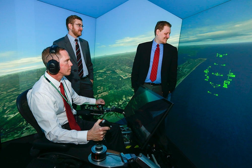 UC grad and Psibernetix President and CEO Nick Ernest, David Carroll, and Gene Lee (seated).