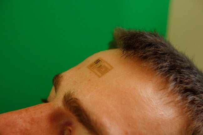 Electronic patch applied to the forehead to measure brain activity. Photo courtesy: John Rogers