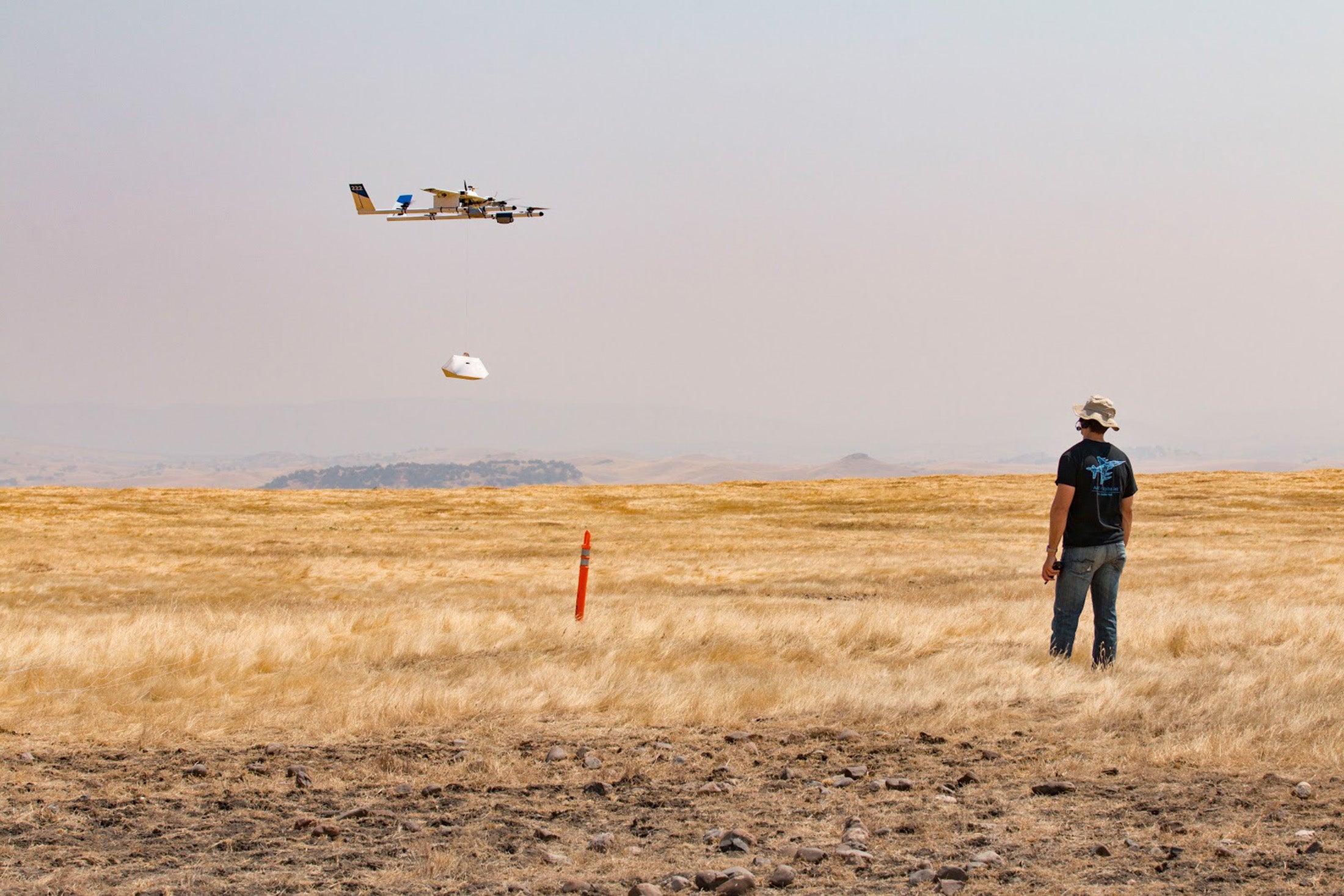 A Project Wing aircraft lowering a package to the ground during recent testing. - Bloomberg