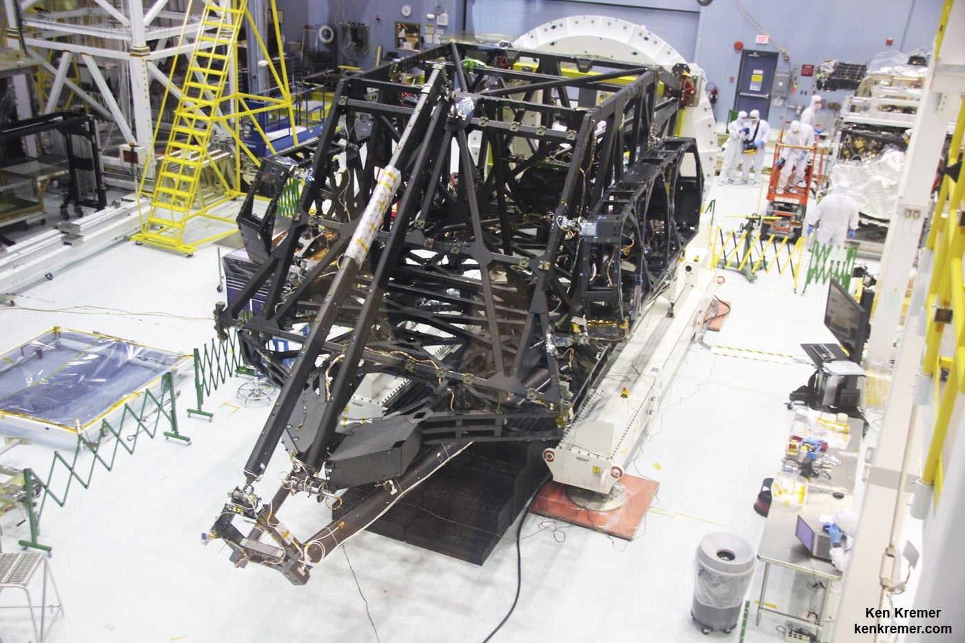 View showing actual flight structure of mirror backplane unit for NASA’s James Webb Space Telescope (JWST) that holds 18 segment primary mirror array and secondary mirror mount at front, in stowed-for-launch configuration. JWST is being assembled here by technicians inside the world’s largest cleanroom at NASA Goddard Space Flight Center, Greenbelt, Md. Credit: Ken Kremer/kenkremer.com