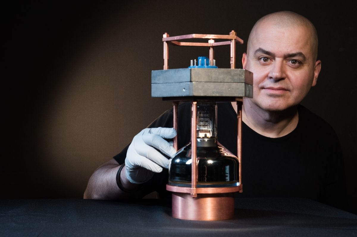 Juan Collar, a professor in physics at the University of Chicago, with a prototype of the world's smallest neutrino detector used to observe for the first time an elusive interaction known as coherent elastic neutrino nucleus scattering.