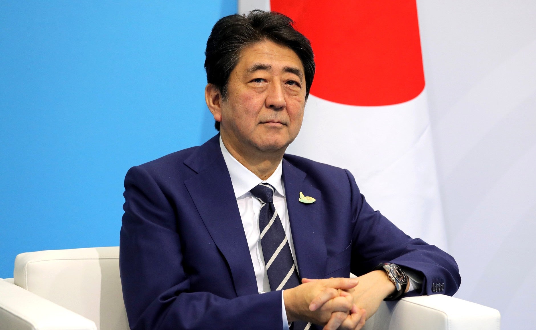 Japanese Prime Minister Shinzo Abe in front of the Japanese flag, earlier in 2017. Abe and the Japanese government are leading a push to provide universal health care to developing countries.