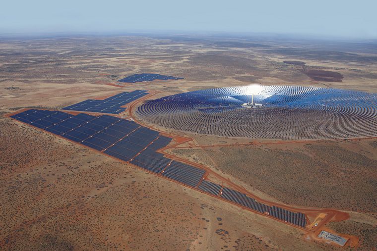 SolarReserve's Redstone molten salt project in Africa, an immense field of mirrors arranged in a circle on reddish dirt.