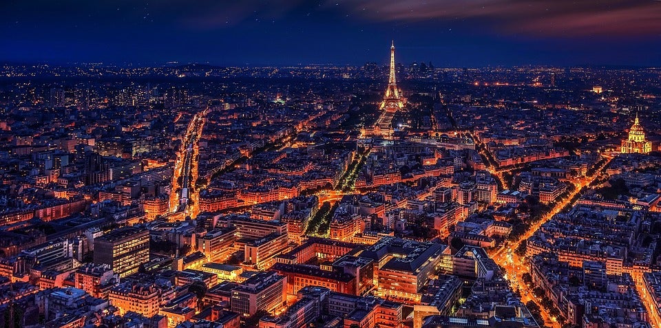 The city of Paris and the Eiffel tower, brightly lit in yellow and orange at night. Soon none of these lights will get their electricity from coal-fired power plants.