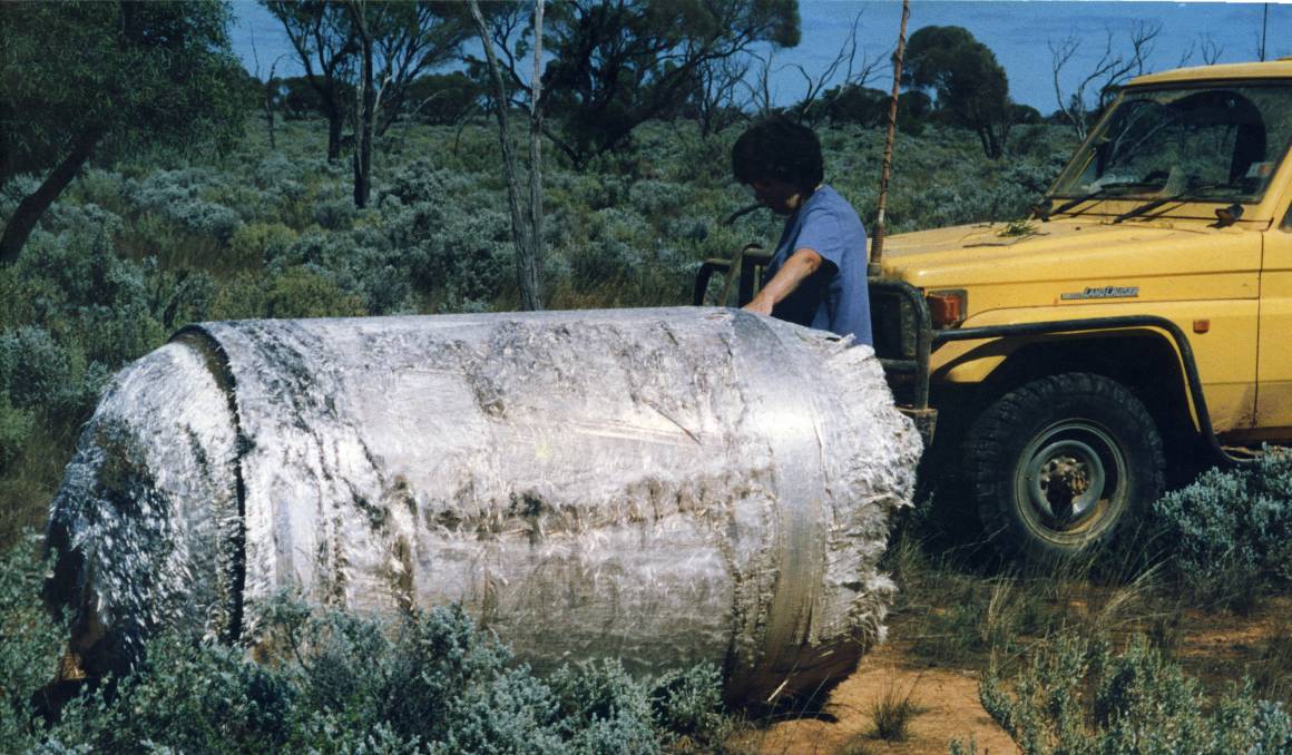 A woman, Pauline Grewar, examines a piece of the crashed Skylab space station on her property in 1979. Scientists have assured that the odds are slim that China's Tiangong-1 will hit any people or property.