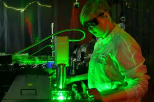 A researcher stands at an ultrafast electron camera that recorded motion in electrons.