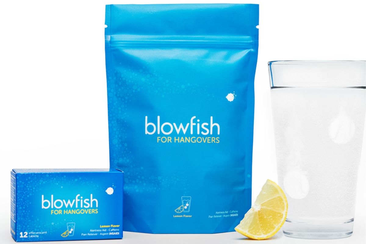 A blue bag of Blowfish for Hangovers next to a glass of water and a lemon slice.